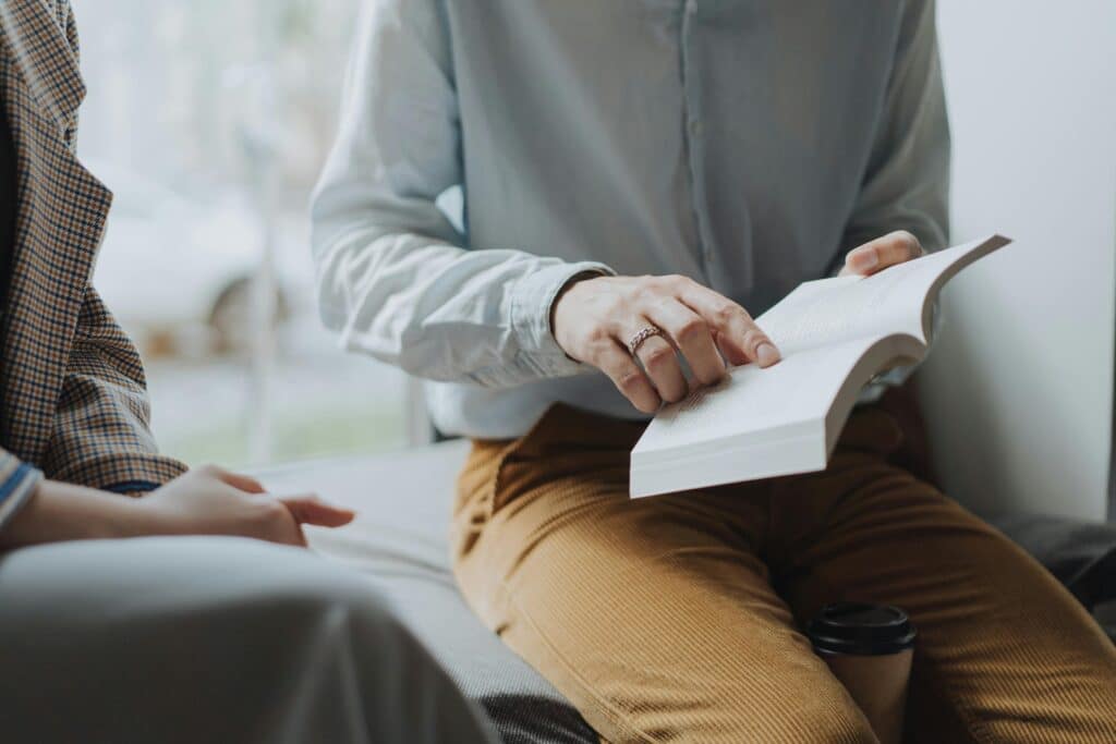 unhommelitunlivreetporteunpantalondevelours